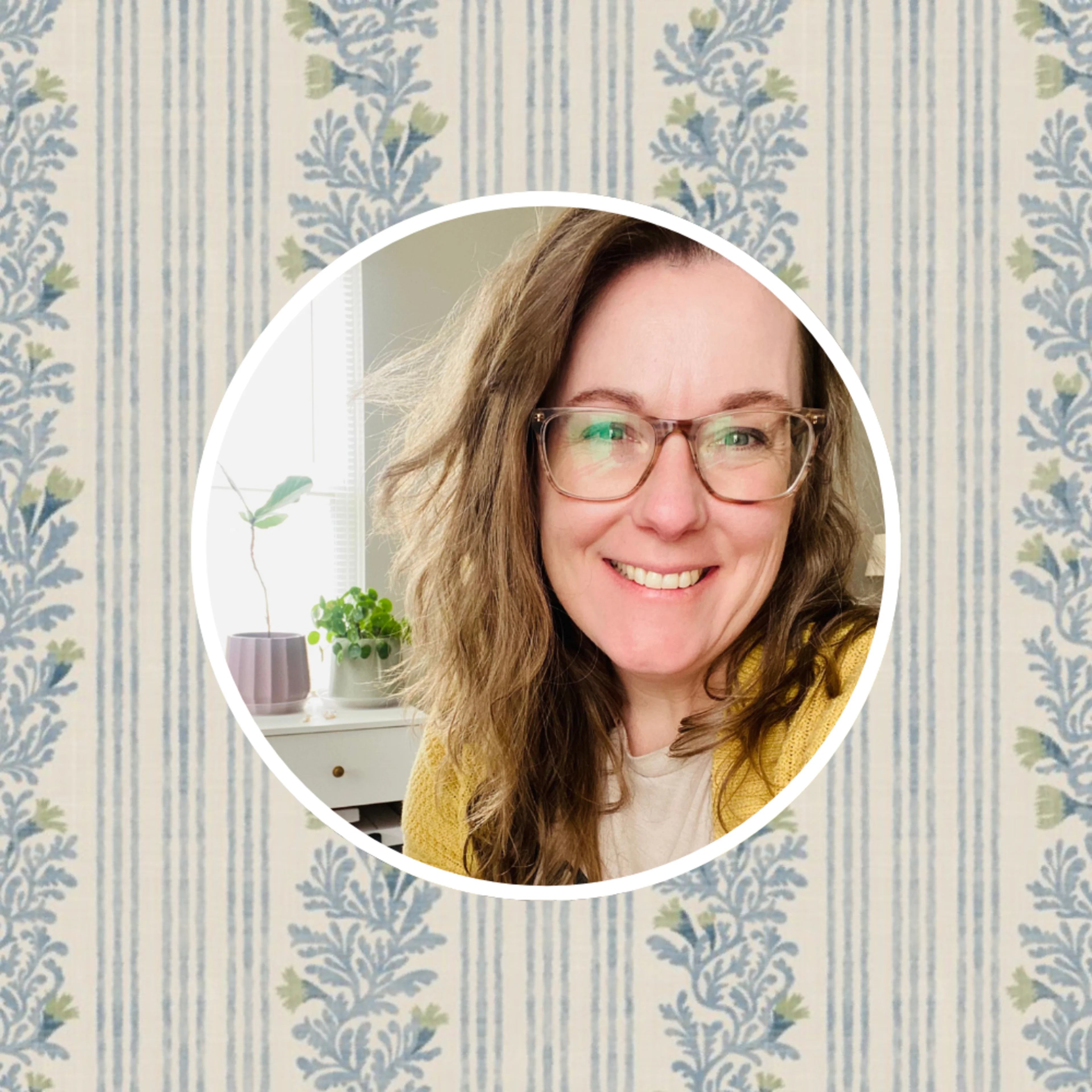 Headshot of artist jen owens in front of one of her designs.