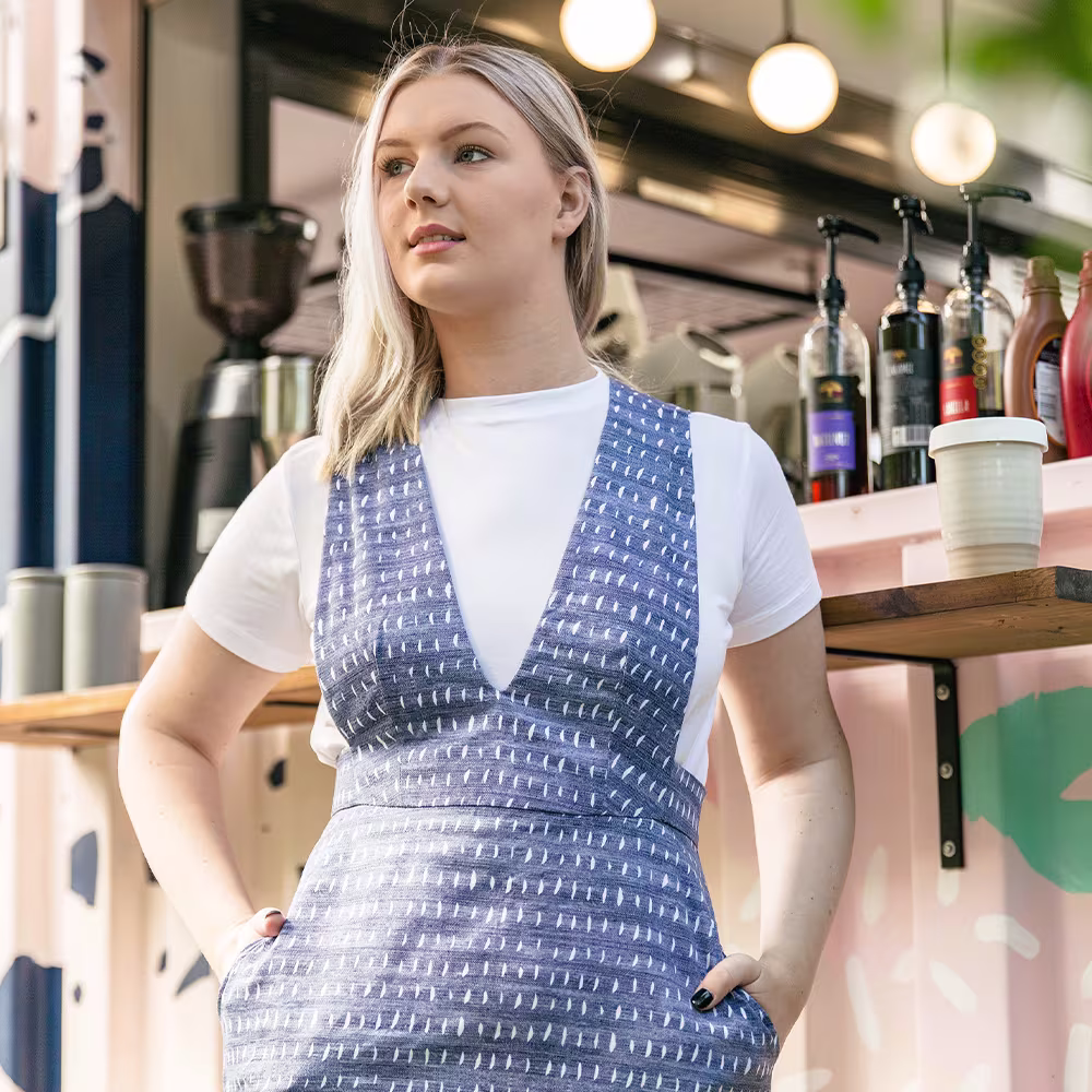 A model wearing a blue jumper dress made with Lightweight Cotton Twill