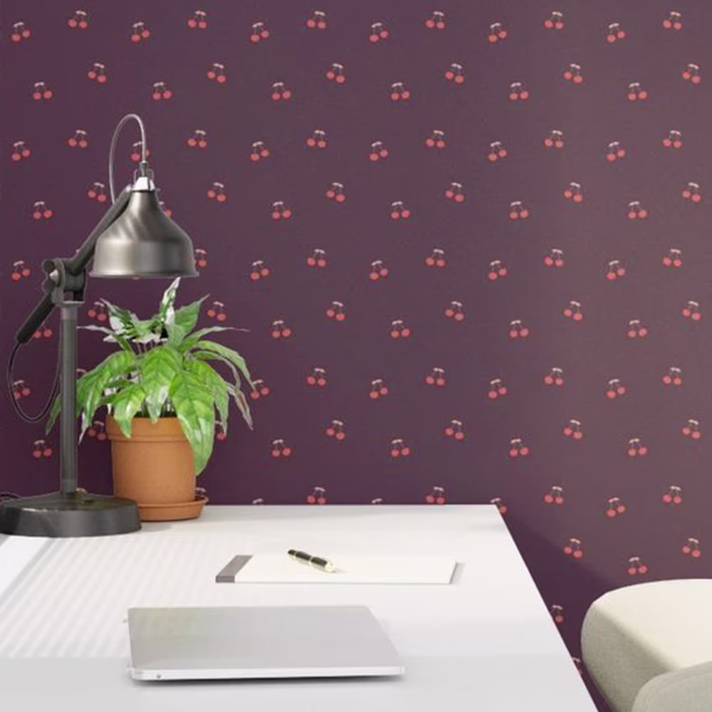 Desk area with maroon cherry wallpaper.