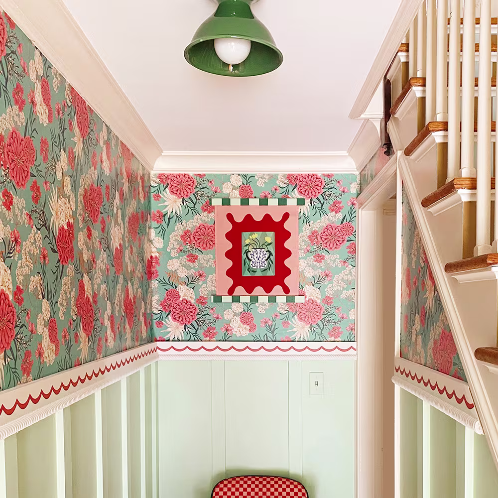 Hall area with pink and teal floral wallpaper.