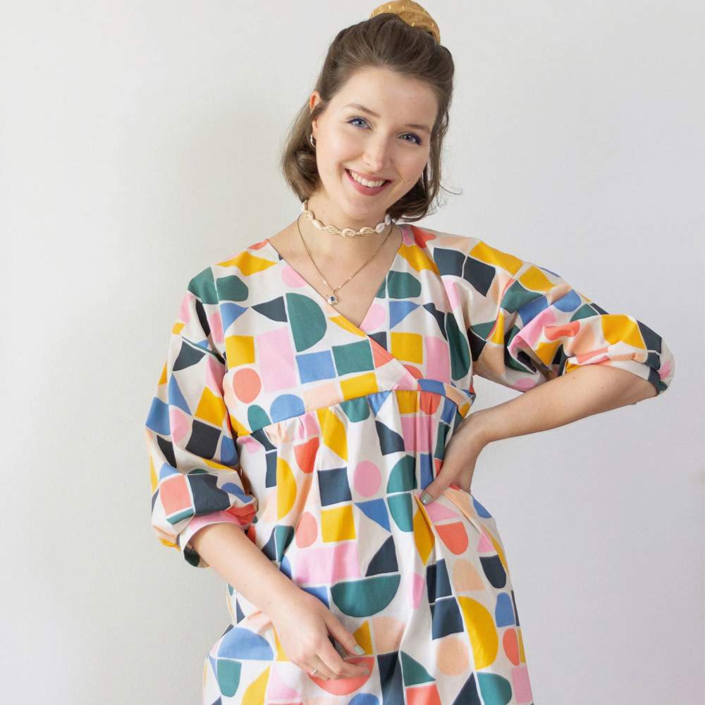 Woman in colorful geometric dress.