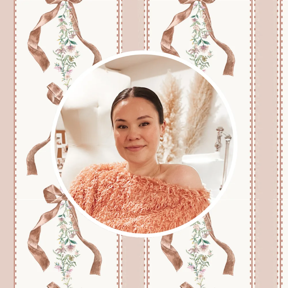 A headshot of Veronica Tucker in front of one of her hand-painted ribbon designs