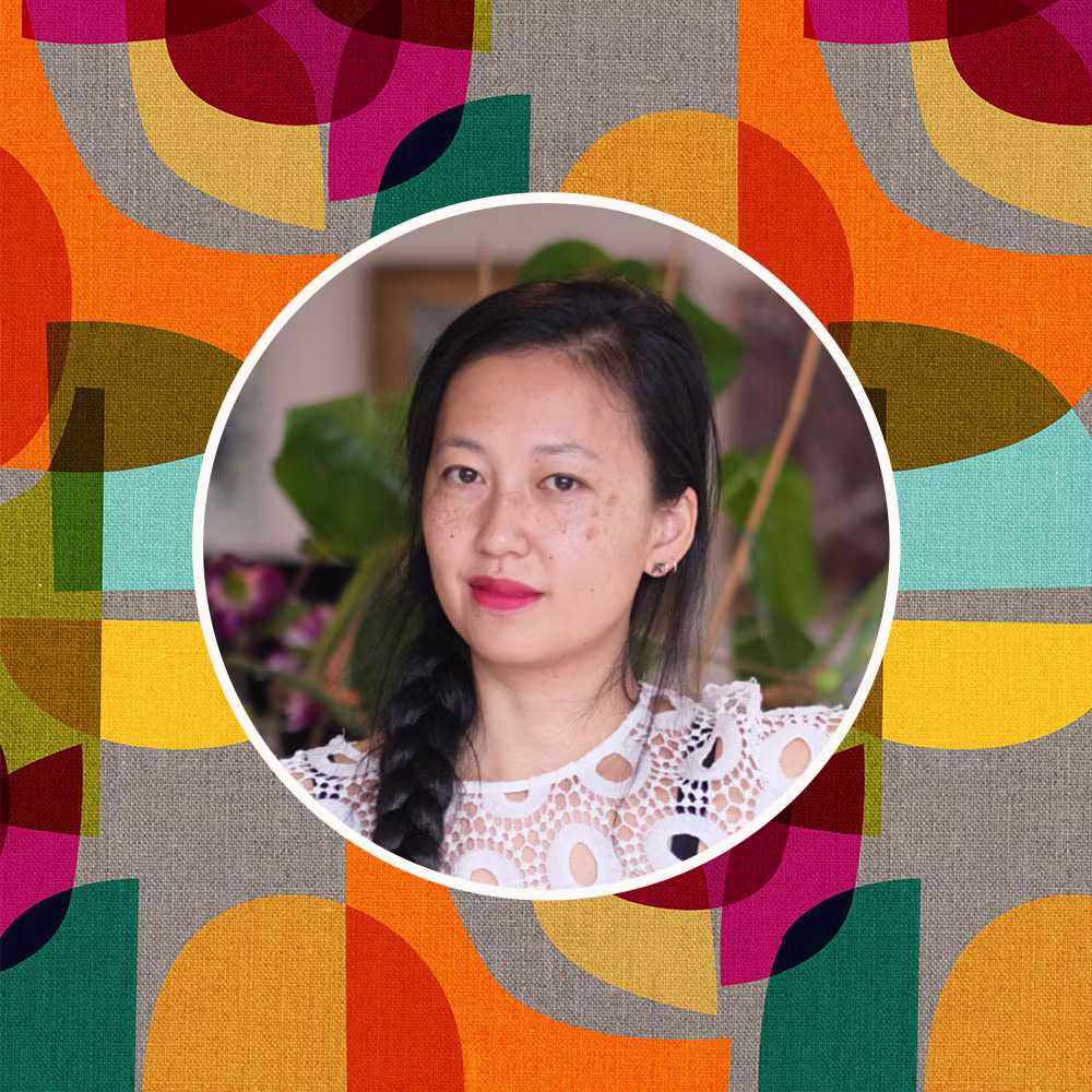 Headshot of Cecilia Mok in front of one of her designed prints.