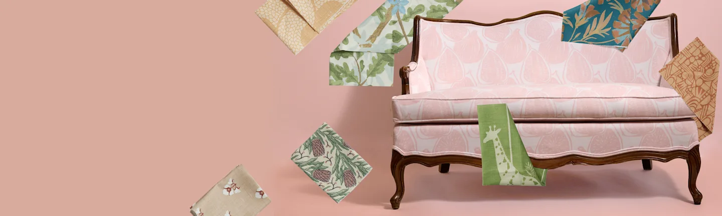 A settee with an assortment of colorful Spoonflower fabrics on a mauve pink background