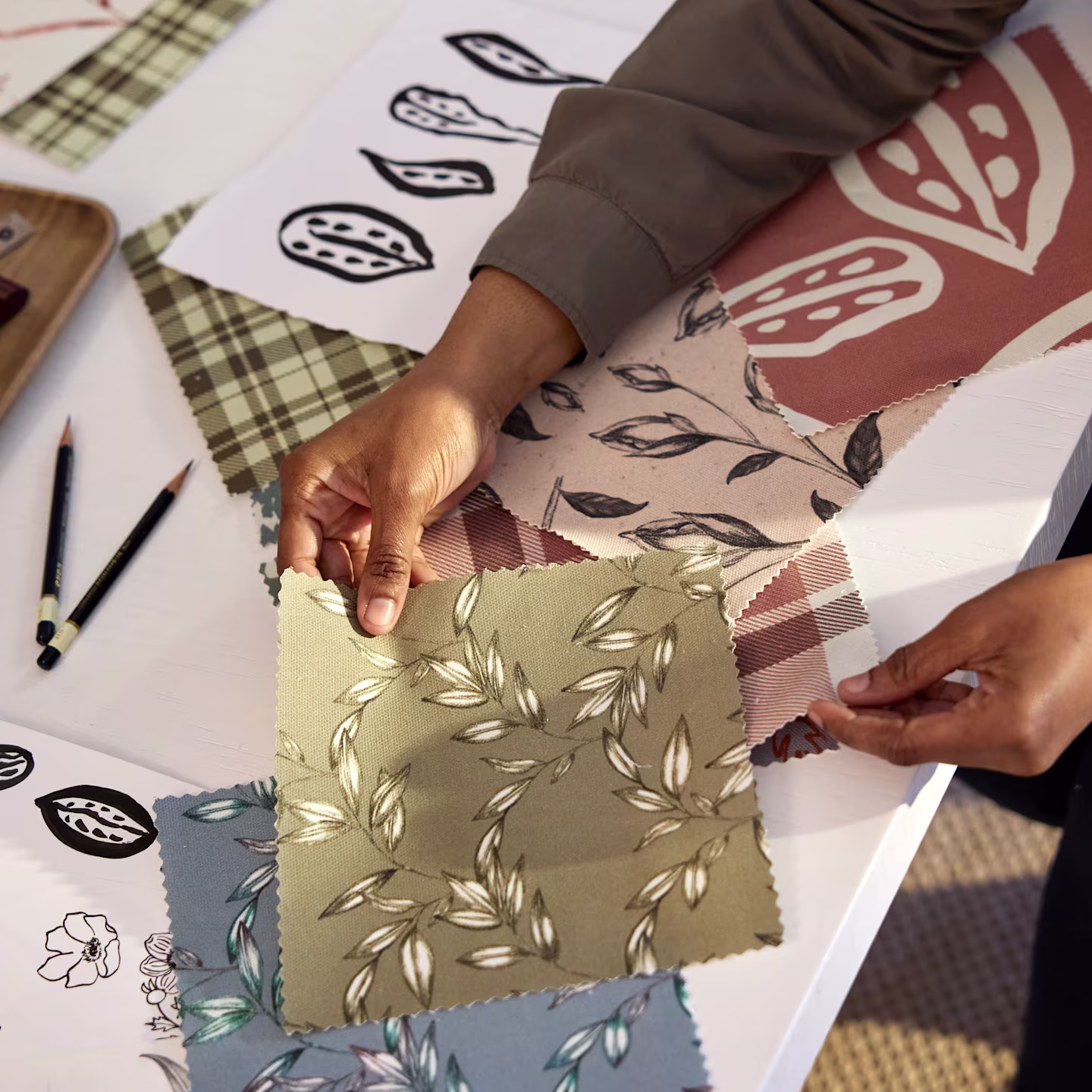 Annette Brown checking swatches featuring her hand-sketched designs