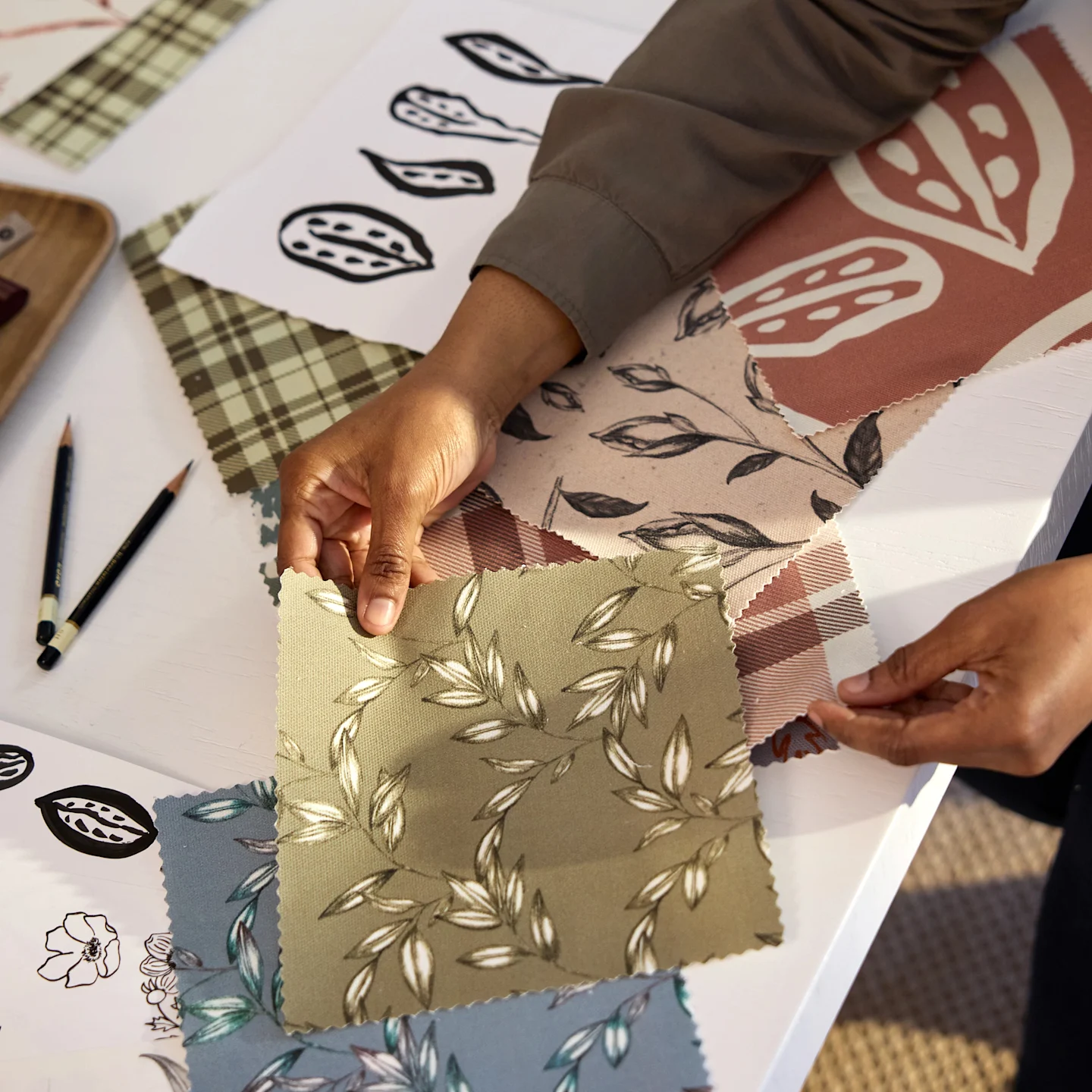 Annette Brown checking swatches featuring her hand-sketched designs