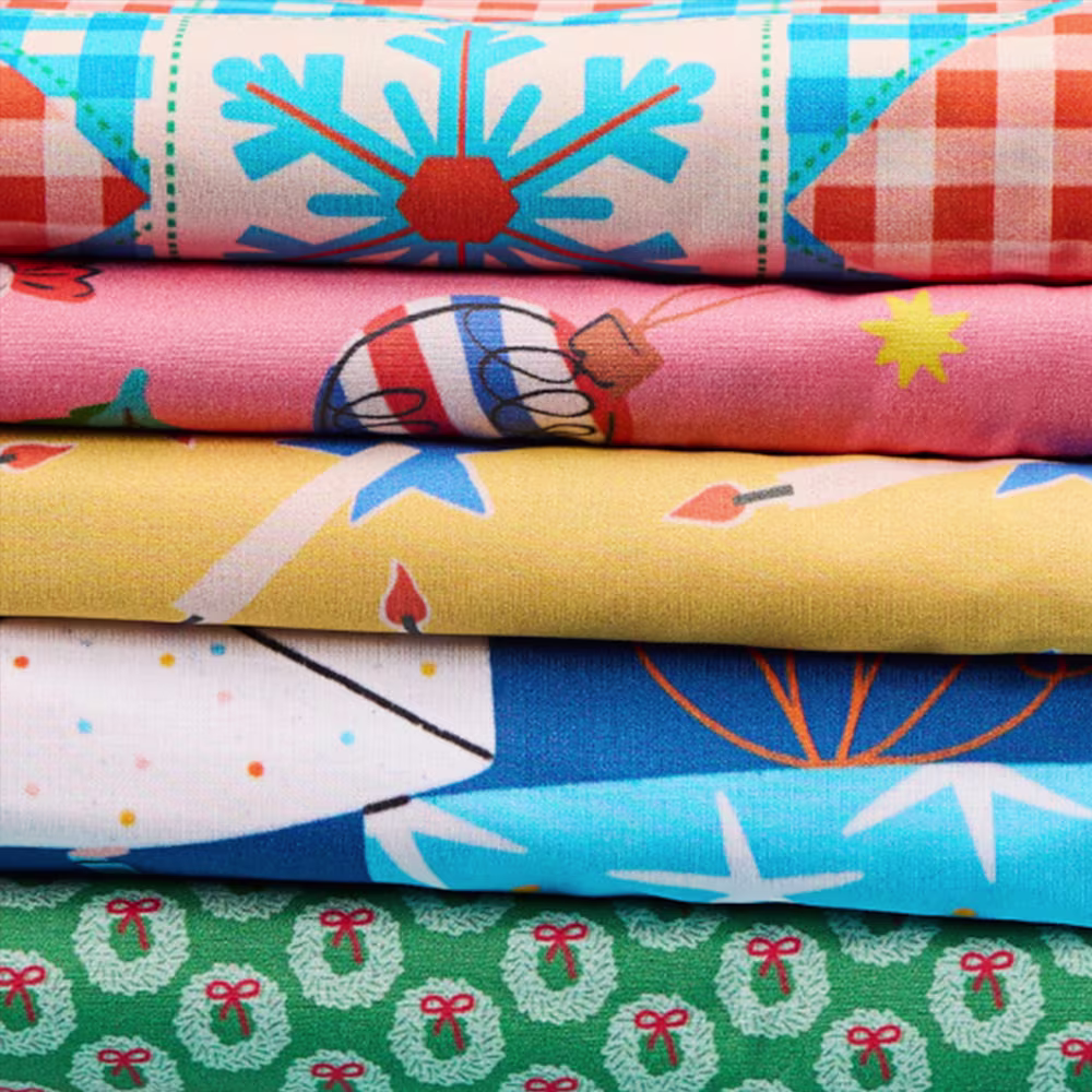 Stack of bright modern christmas fabrics
