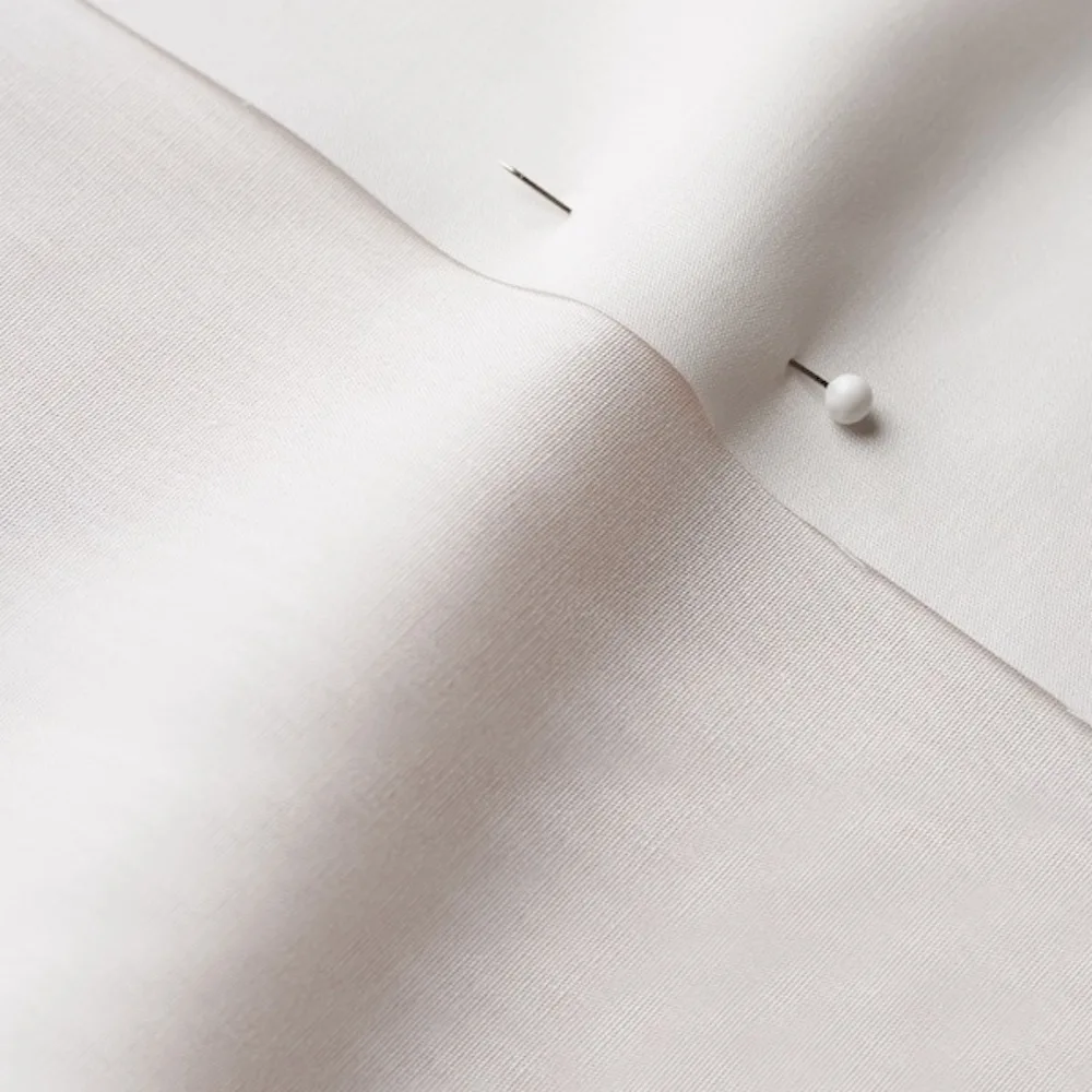 Cotton Poplin fabric with a seam and a pin through 