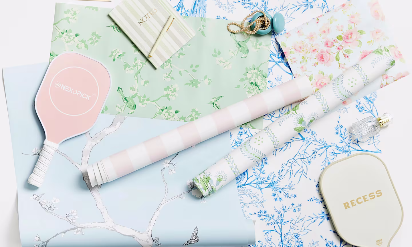 Preppy green, pink and blue wallpaper swatches styled together.