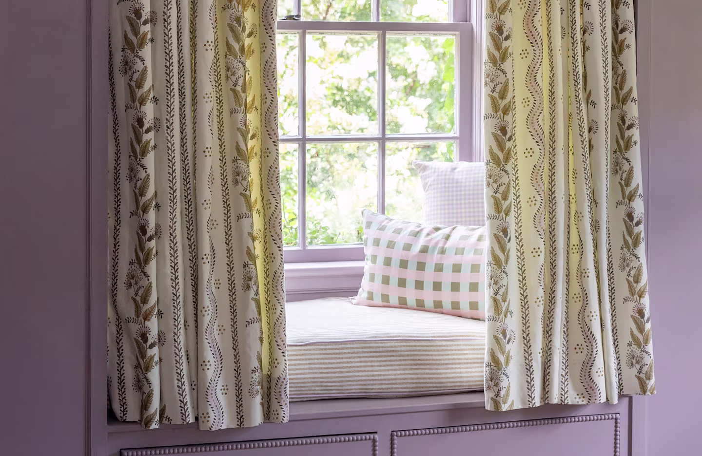 Window seat with curtains, pillows, and cushion