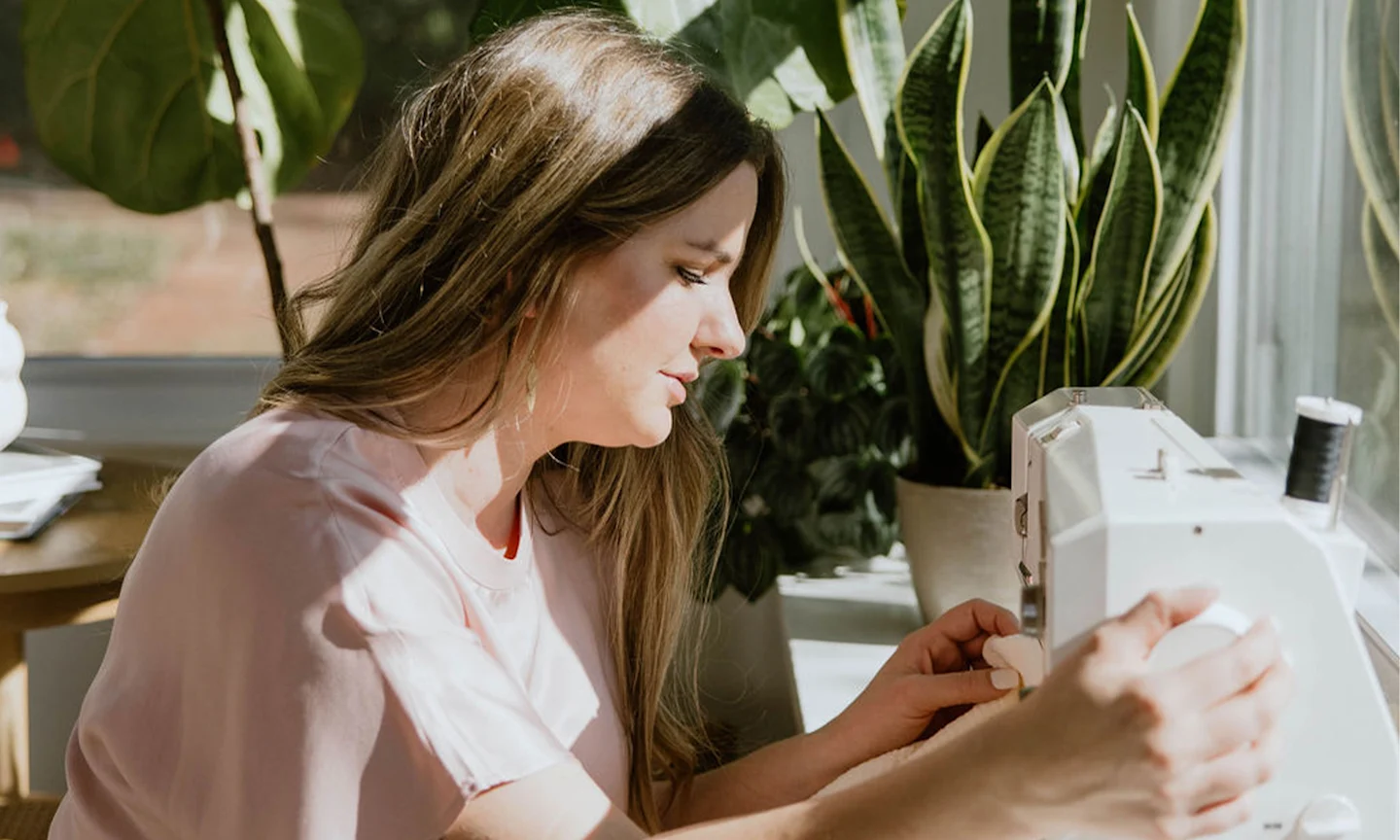 Amelia McCall sits at her sewing machine
