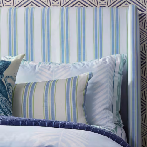 Blue and white striped pillows and headboard