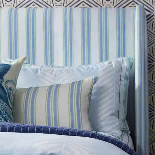 Blue and white striped pillows and headboard