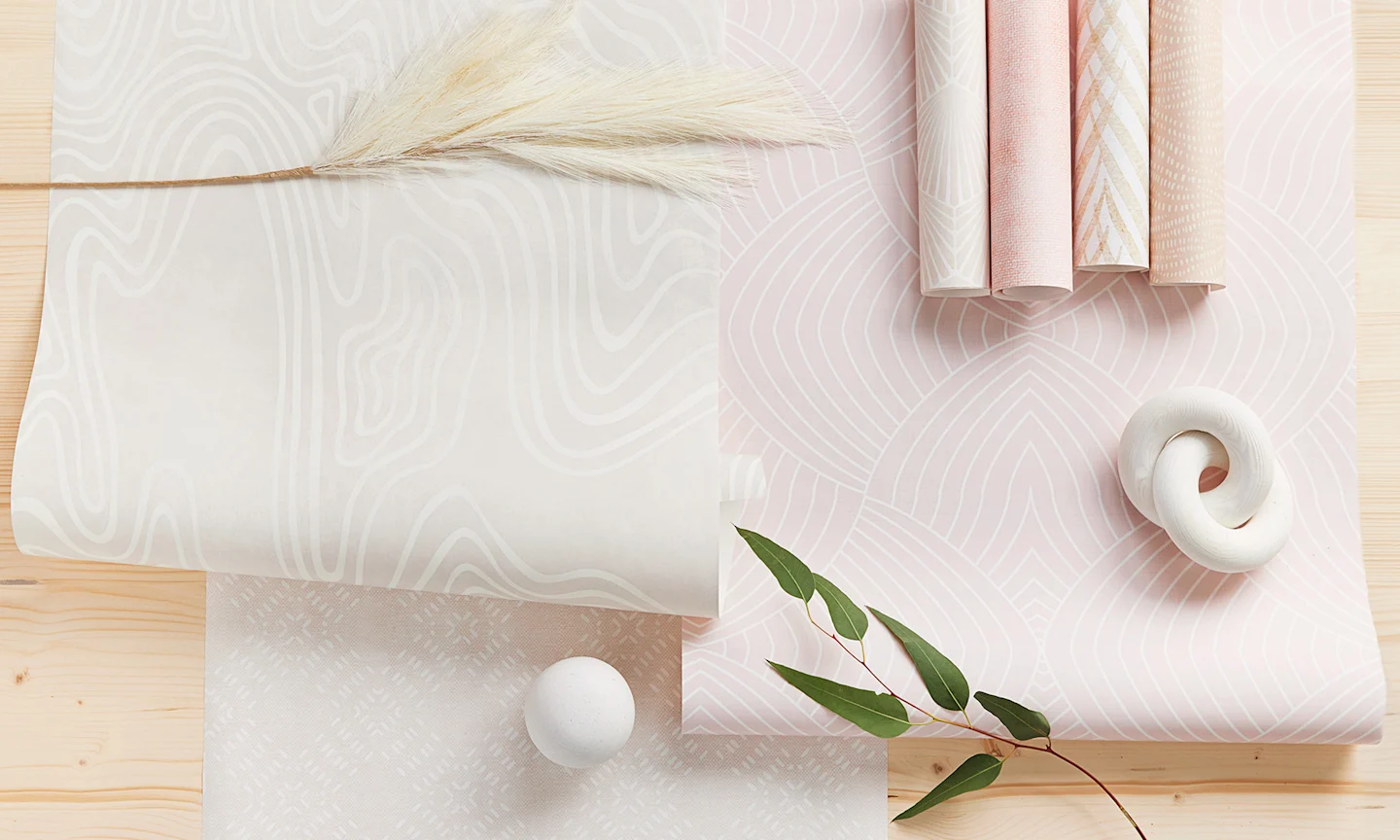 Warm minimalist designed wallppaper rolls styled together.