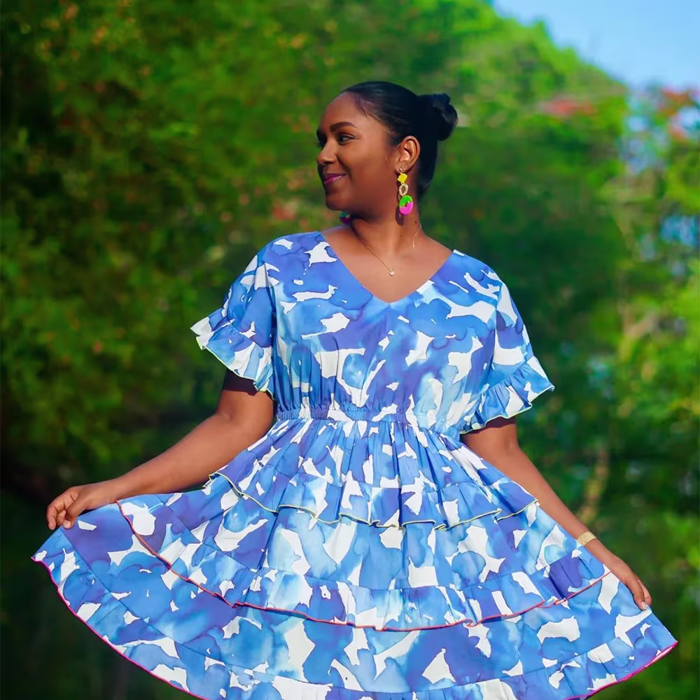 A model in a blue and white dress made with Cotton Lawn