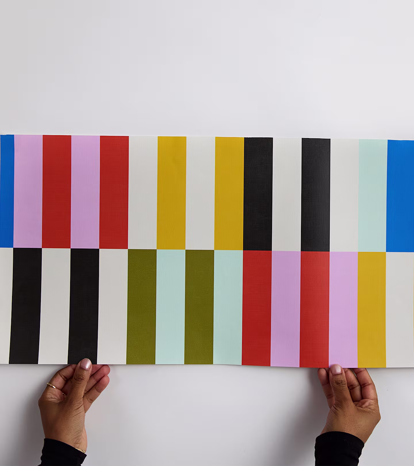 Hands holding a wallpaper sample
