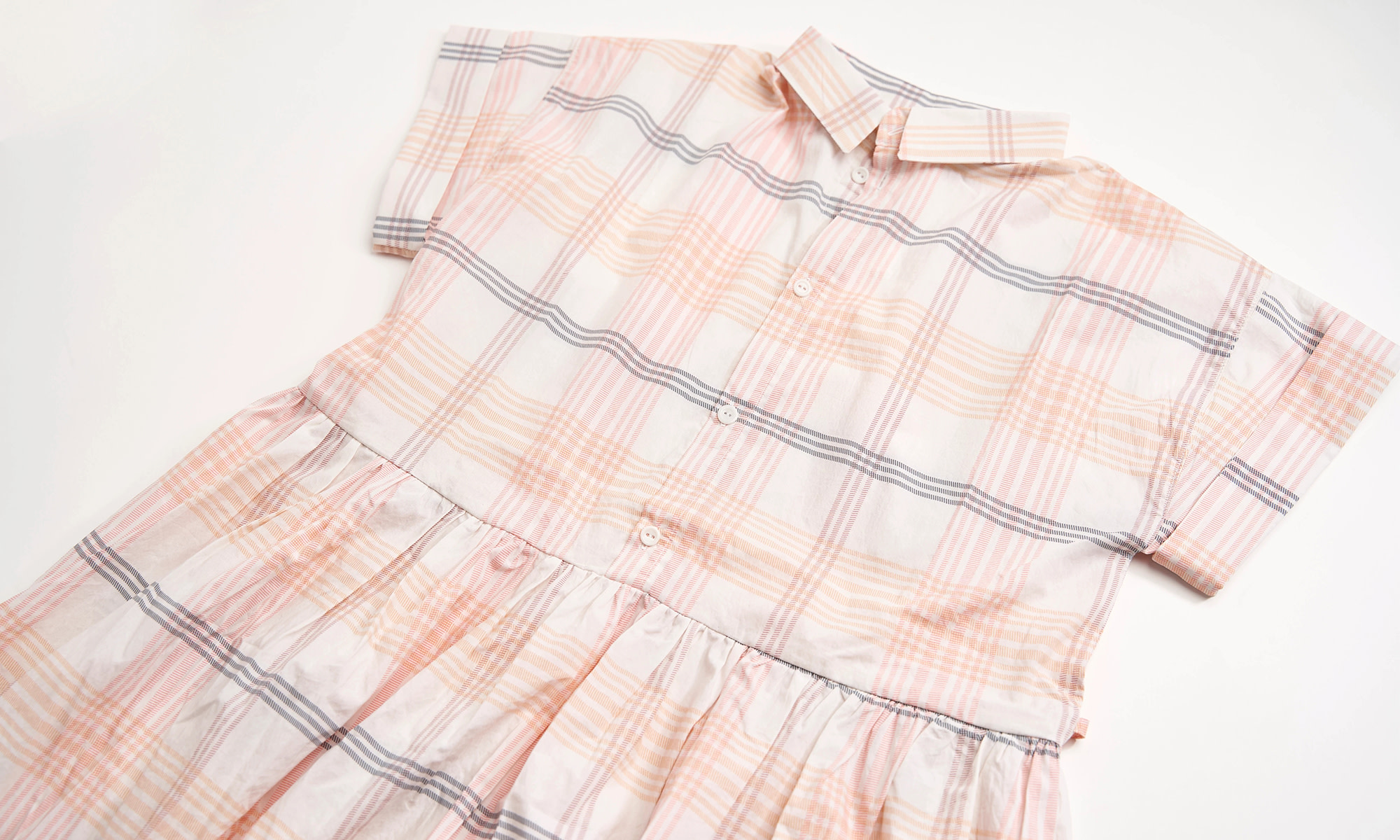 Plaid dress laying out.