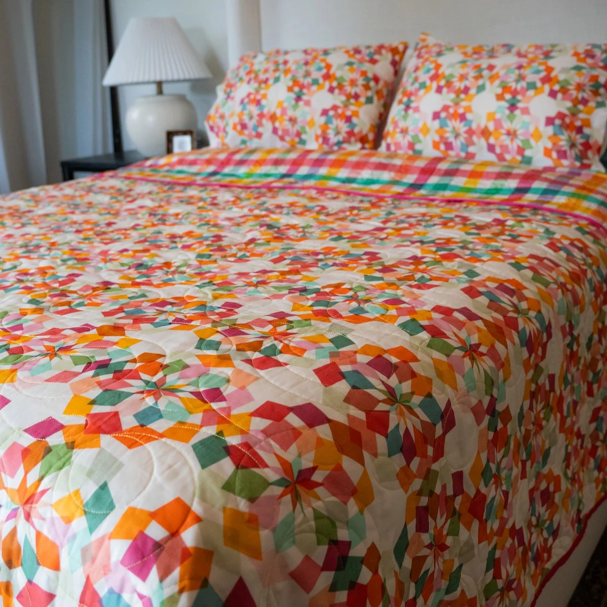 The reverse side of a bright modern quilt made by Vickeidy Plybon with wide cotton sateen 6.5