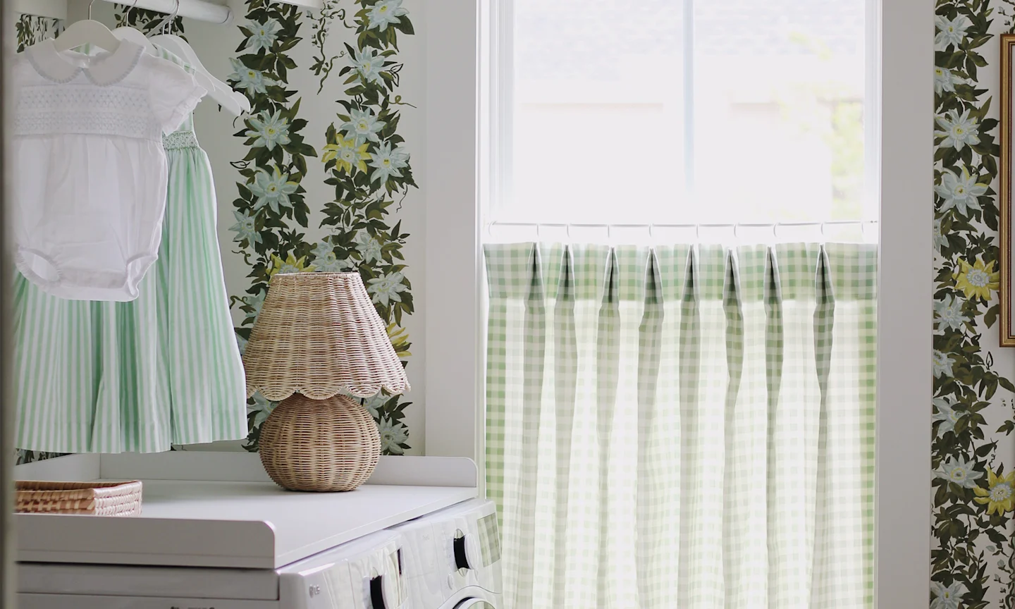 Laundry room with leavy floral stripe wallpaper and a green gingham cafe curtain.