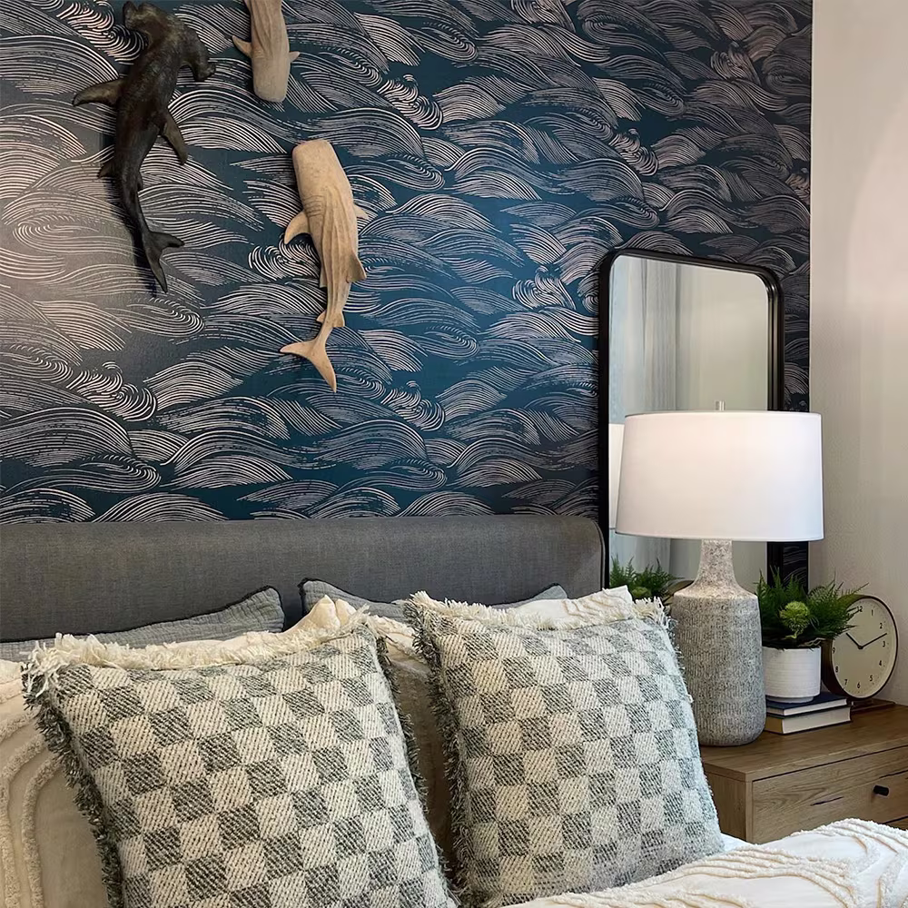 Bedroom with wave design wallpaper.