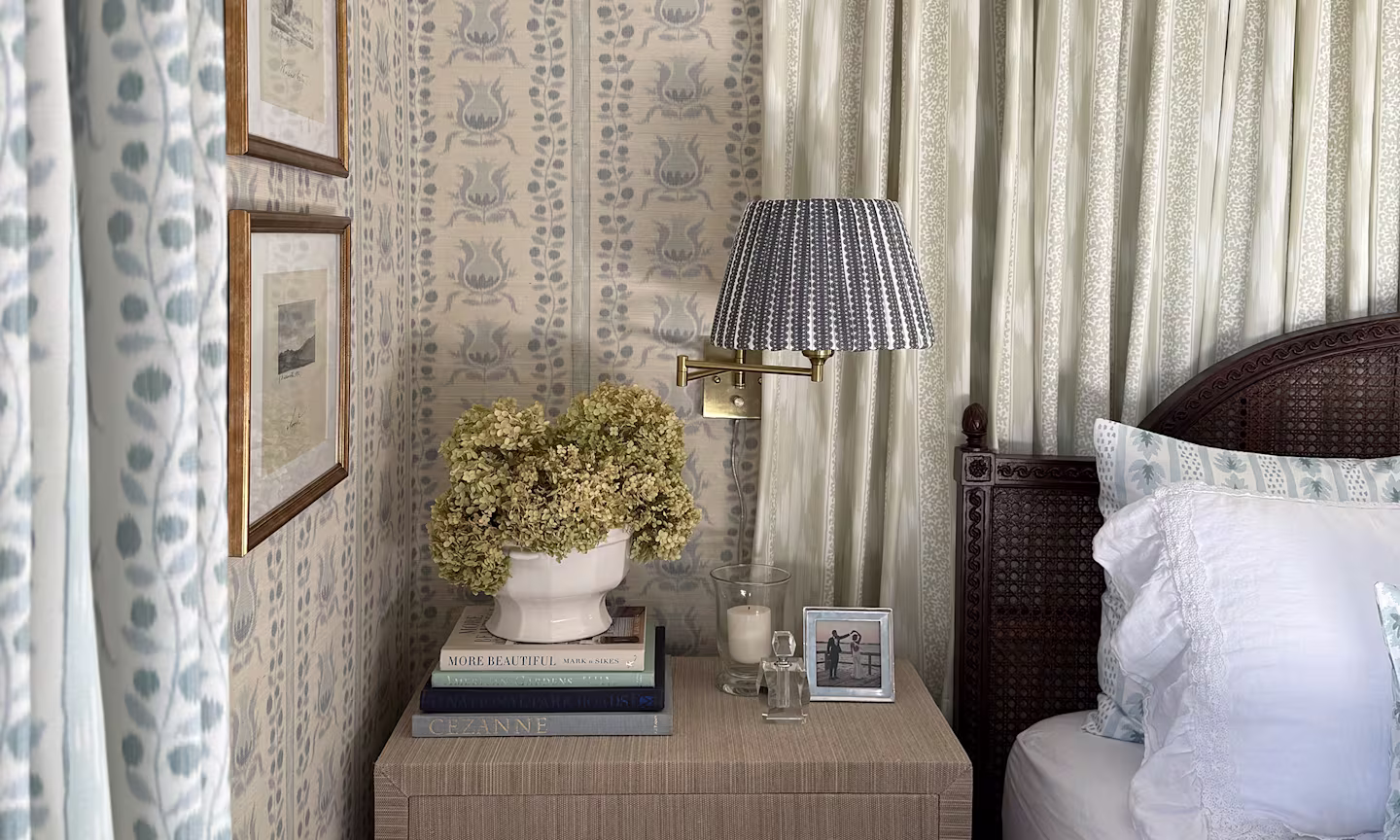 Bedroom with ikat pomegranates wallpaper and coordinating curtains, fabric accents and bedding.