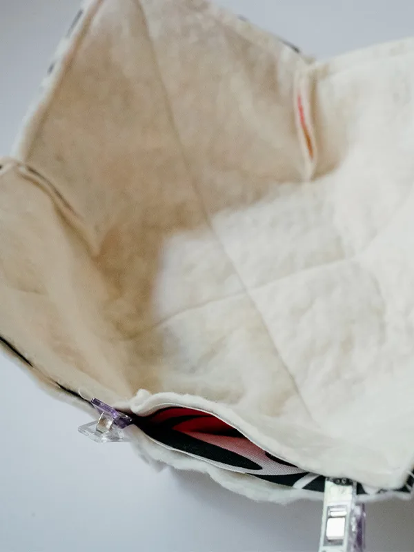 The bowl cozy’s edges have been sewn together, except for a 3” opening, which is visible.