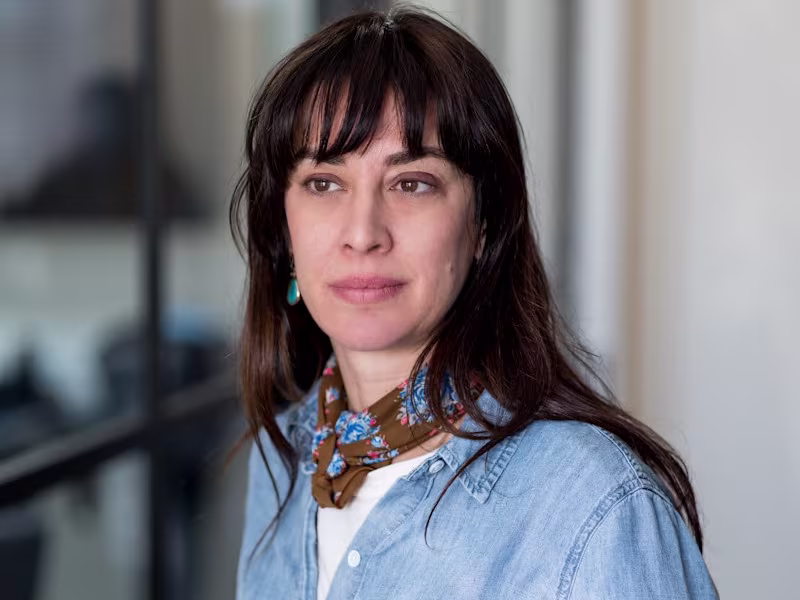 Headshot of Ps & Daughters Jane Beiles wearing a denim shirt