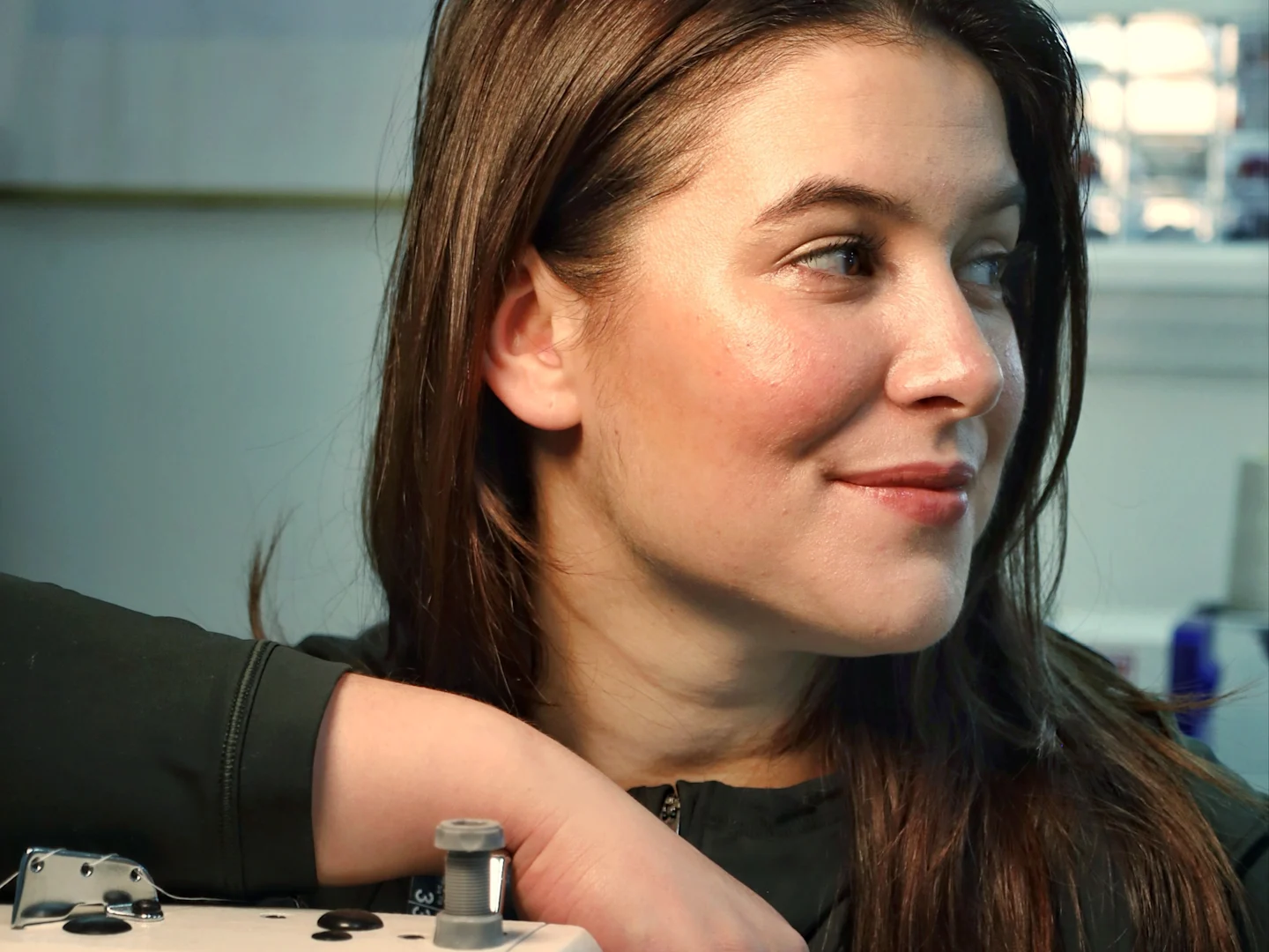 A headshot of Gabriela Fasola at her sewing machine