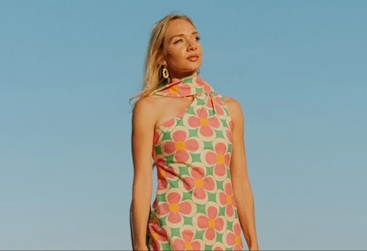 A model wearing a retro floral maxi dress made with Essex Linen