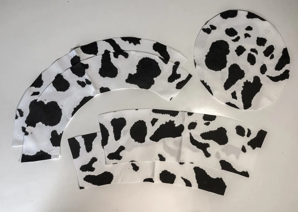 Bucket hat cut fabric pieces laying on a table
