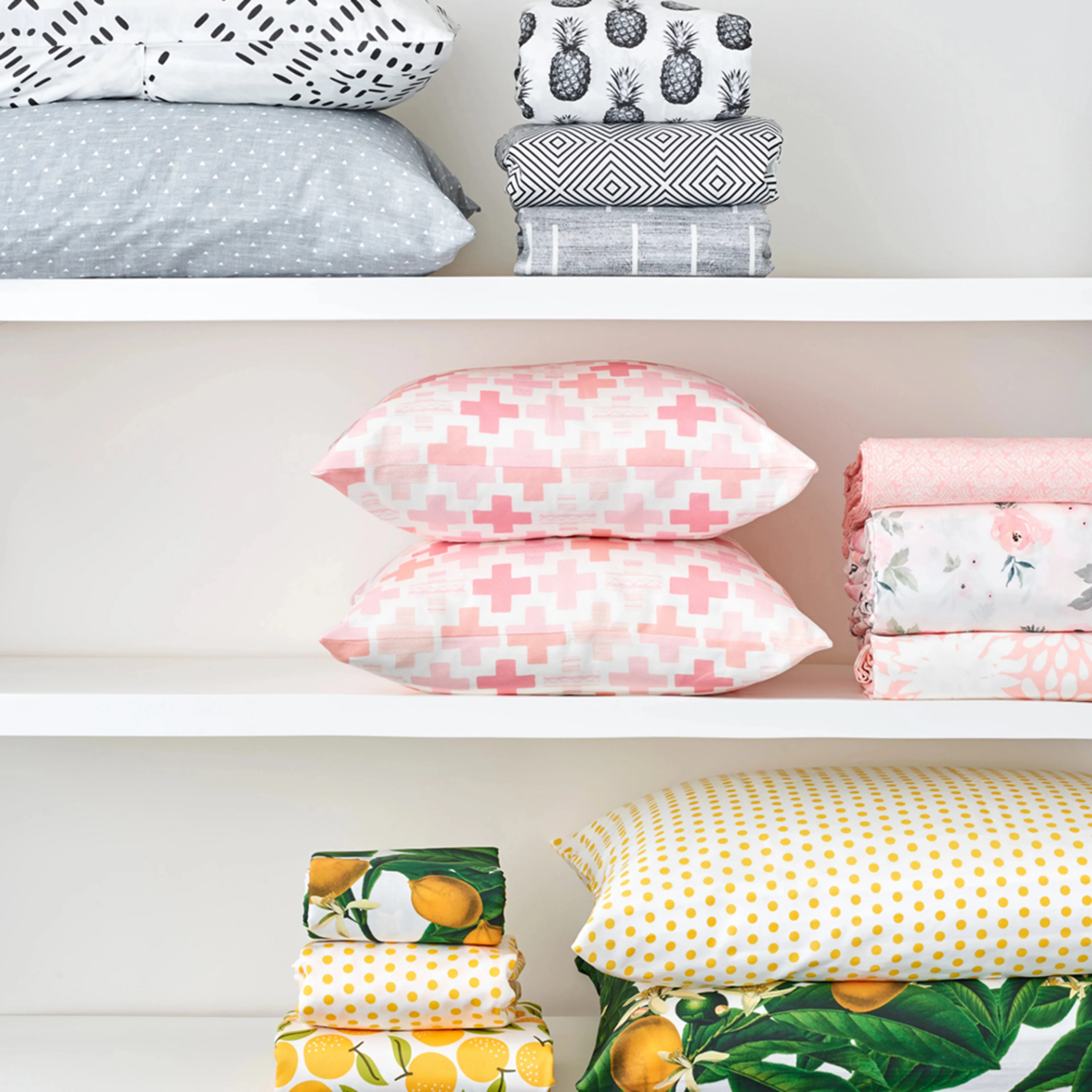 Stacks of colorful coordinating sheets and pillows