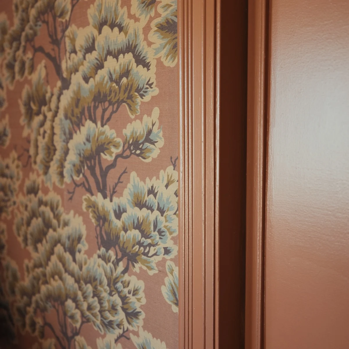 closeup of grasscloth wallpaper and siena paint
