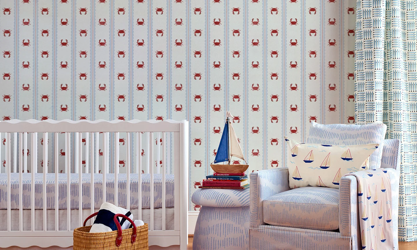 Nursery with striped crab wallpaper.