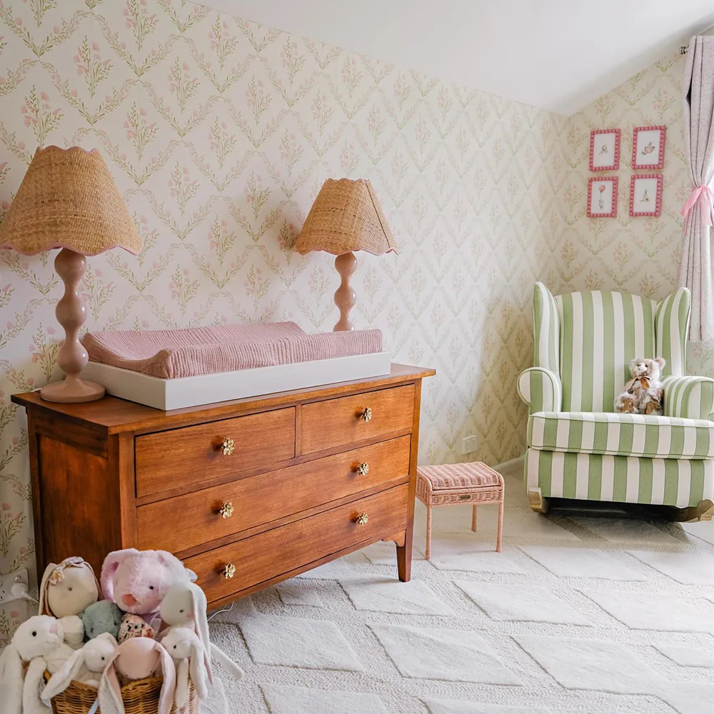 Nursery with pink floral trellis wallpaper