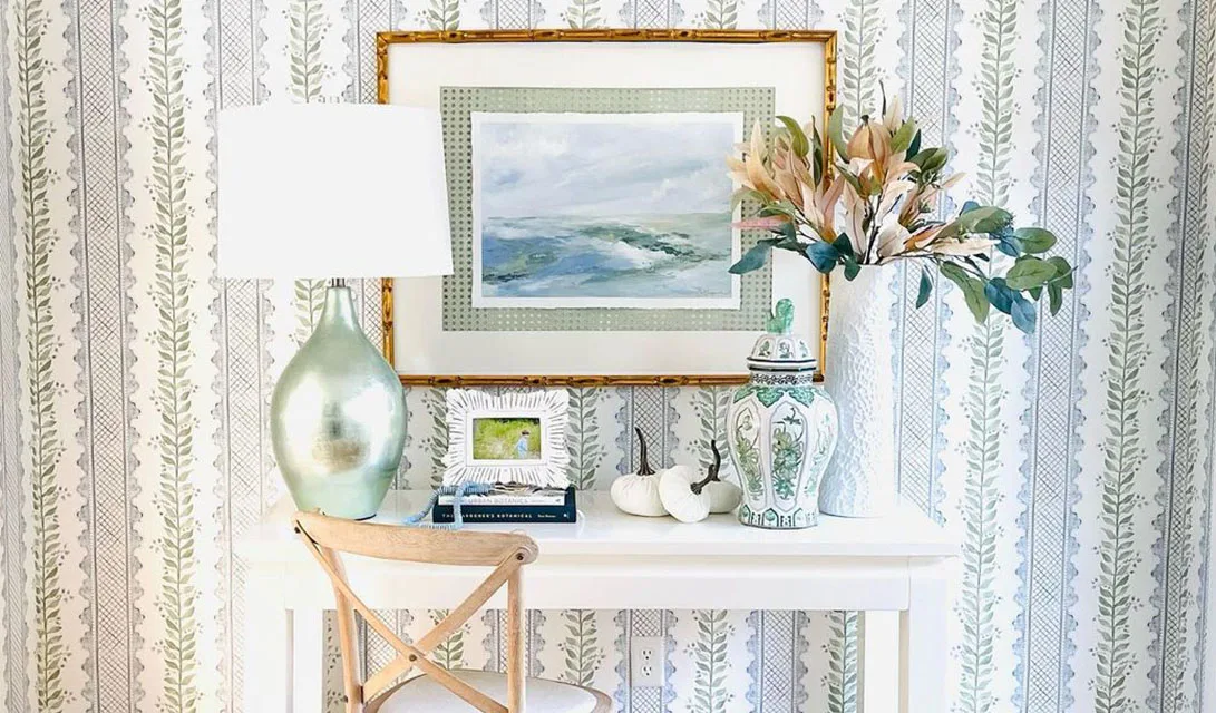 An elegant entryway with sophisticated blue and green striped wallpaper