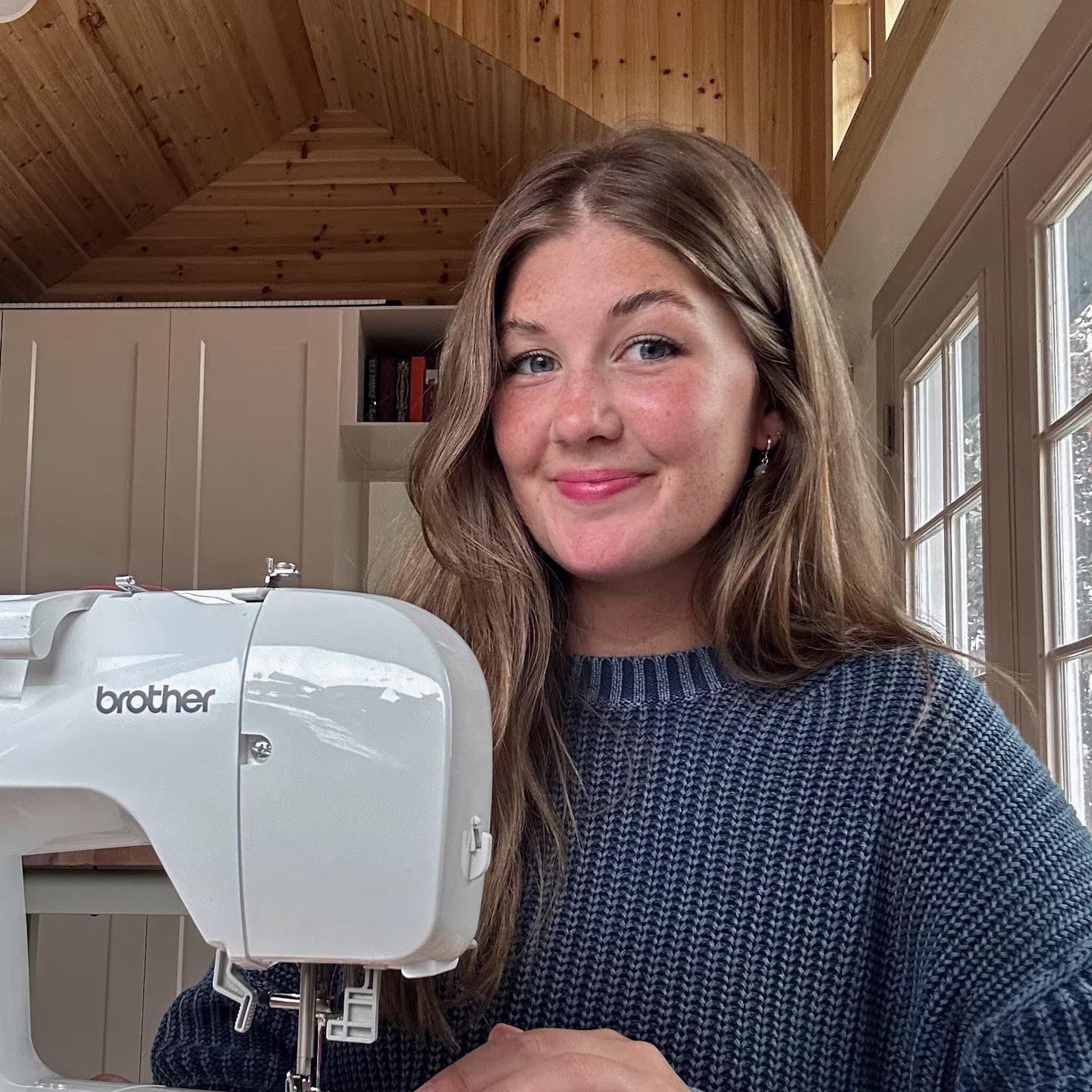 A headshot of Sydney Graham at her sewing machine