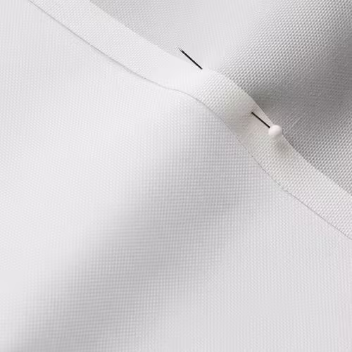 A close-up photo of white fabric with a pin running through it