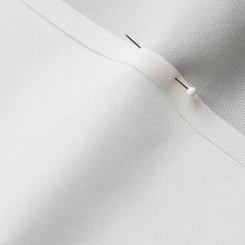 A close-up photo of white fabric with a pin running through it