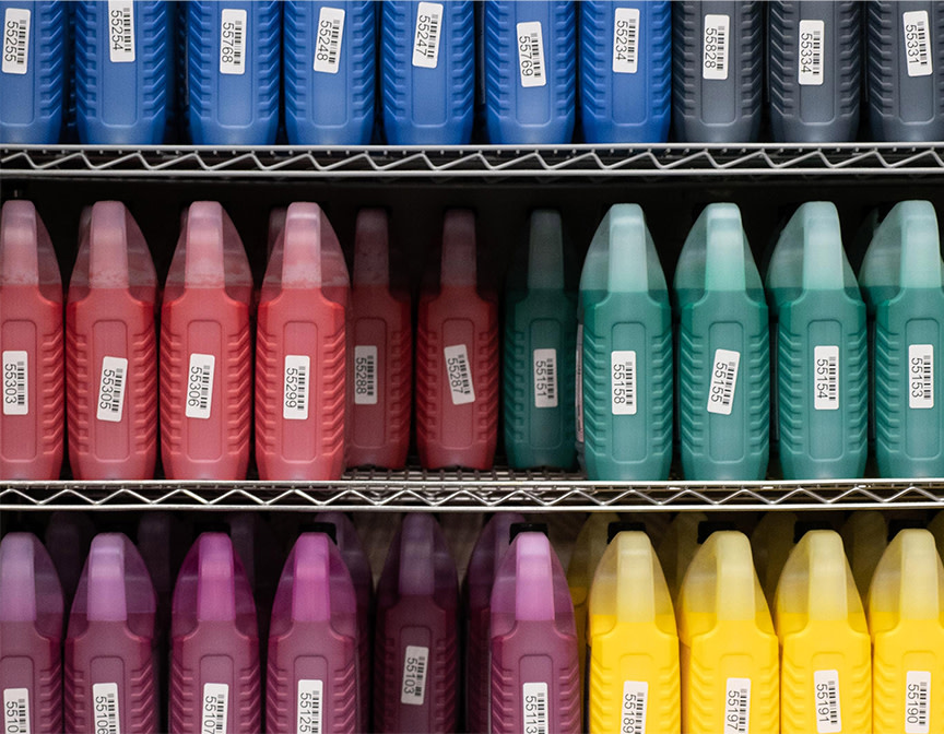 Shelf with big jugs of ink
