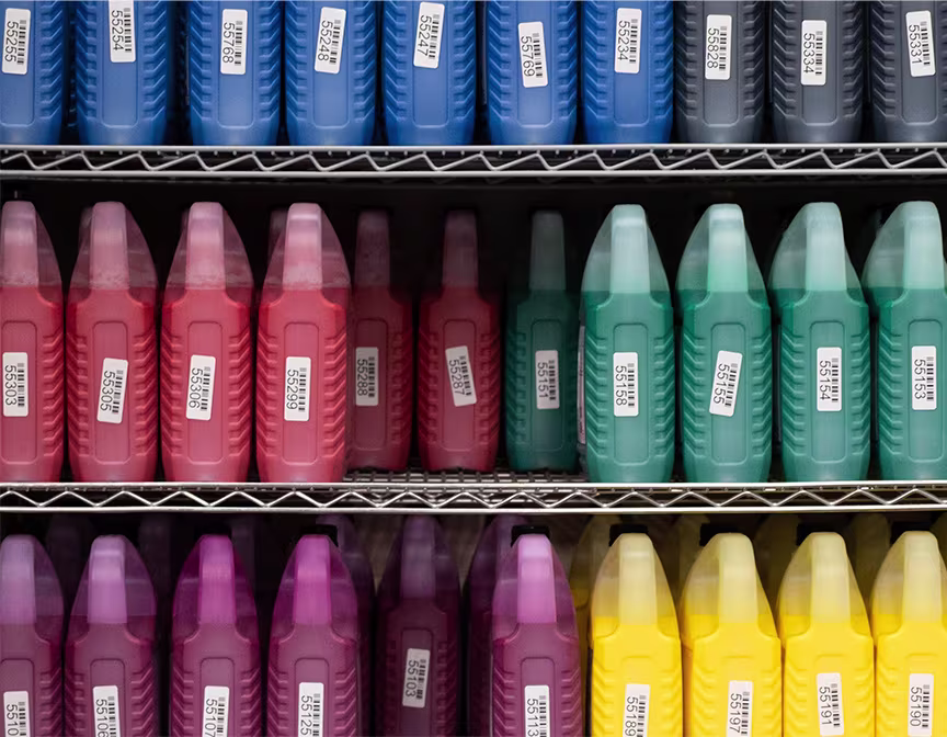 Shelf with big jugs of ink