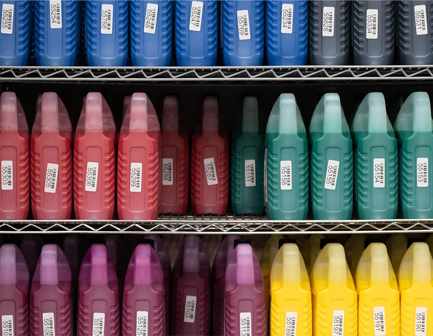 Shelf with big jugs of ink