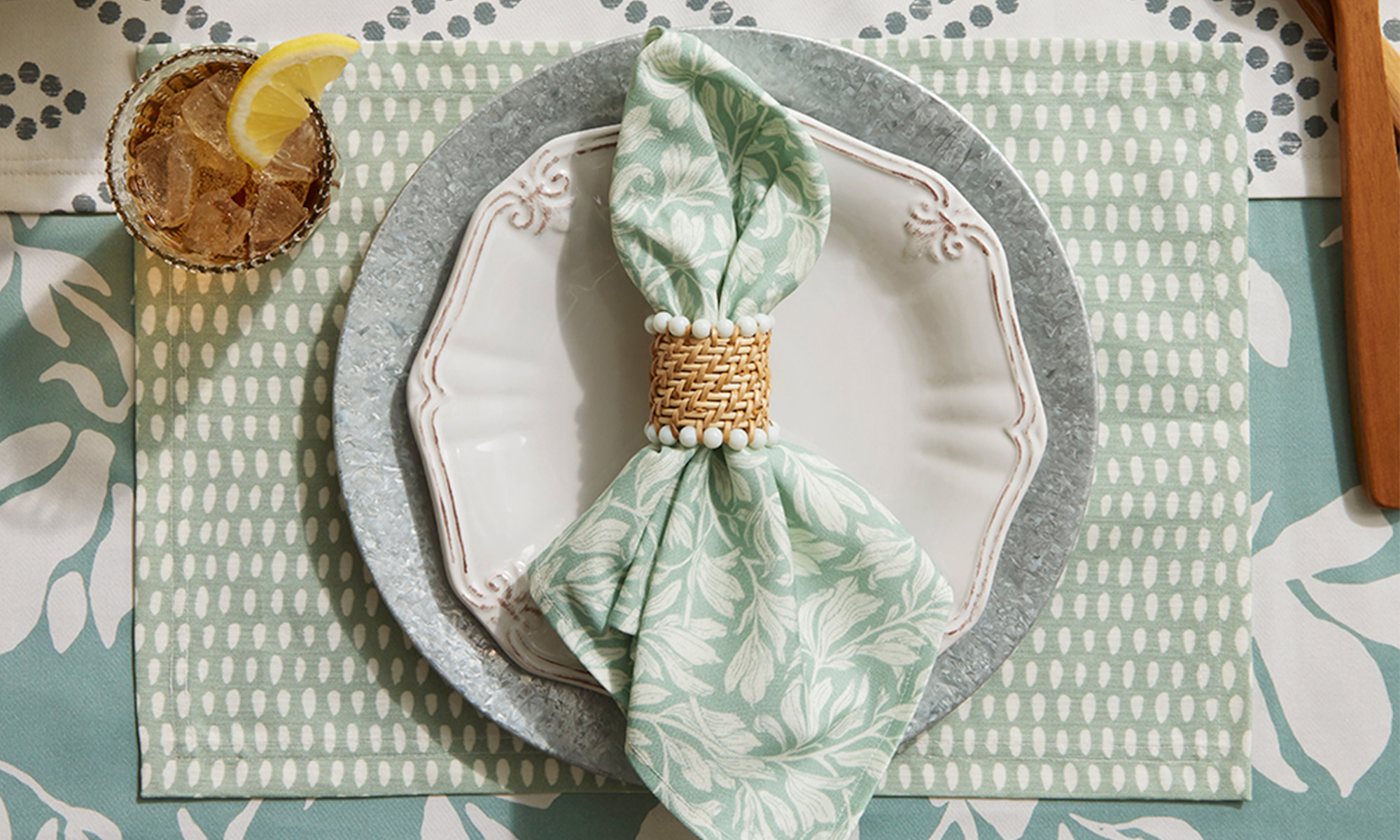 dining place setting with a mint green napkin and placemat.