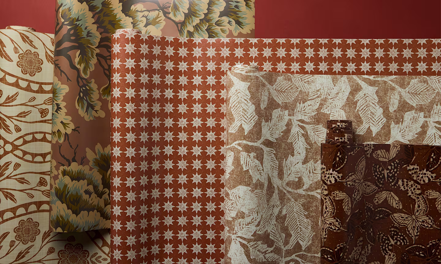 Rolls of terracotta red wallpapers.