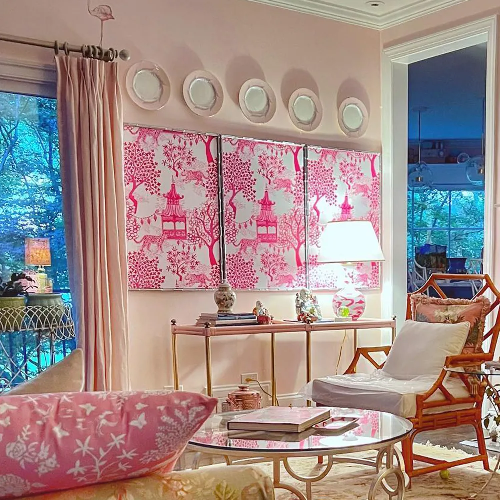 Living space with art made of pink peel and stick wallpaper.