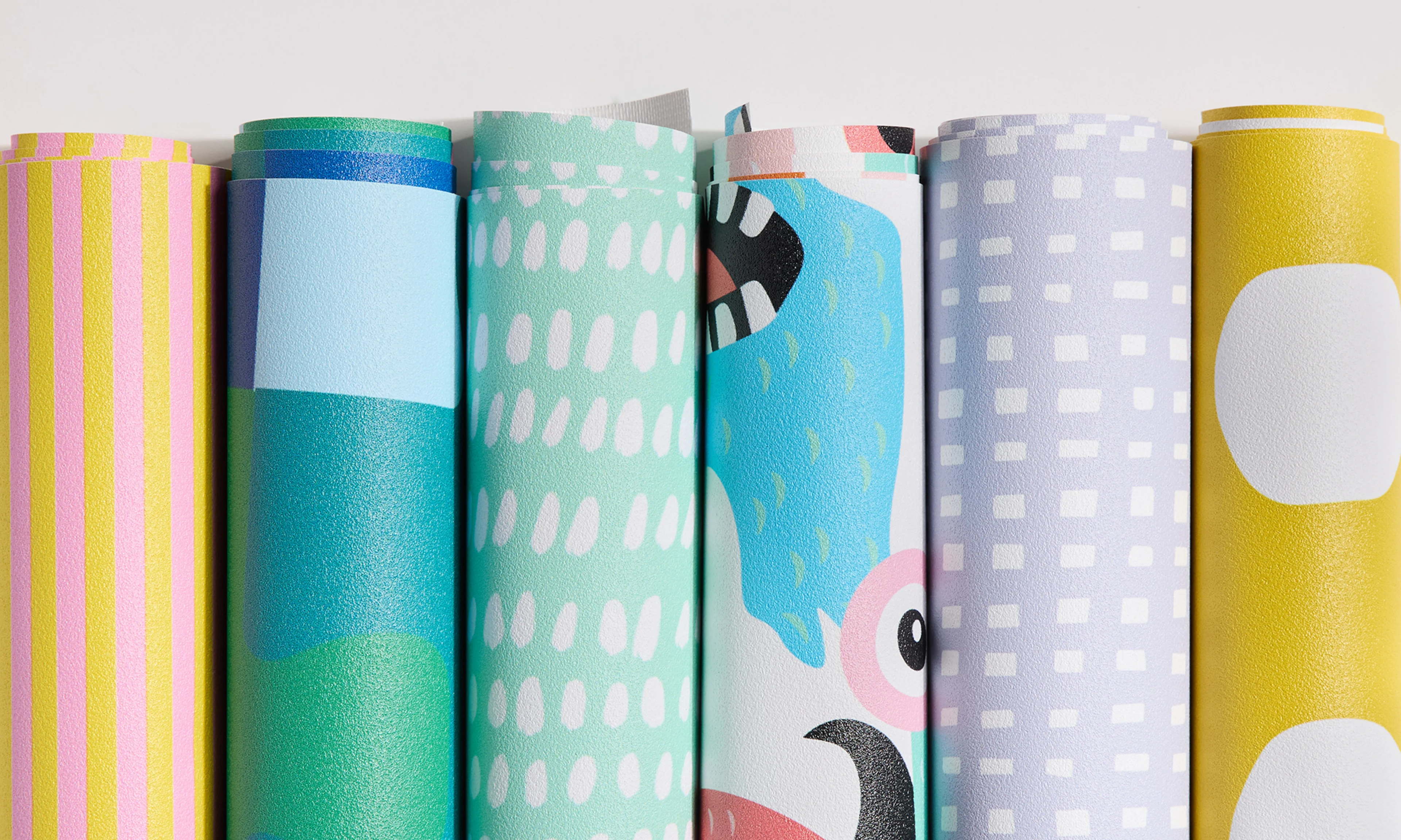 Rolls of vinyl wallpaper with kid friendly designs.