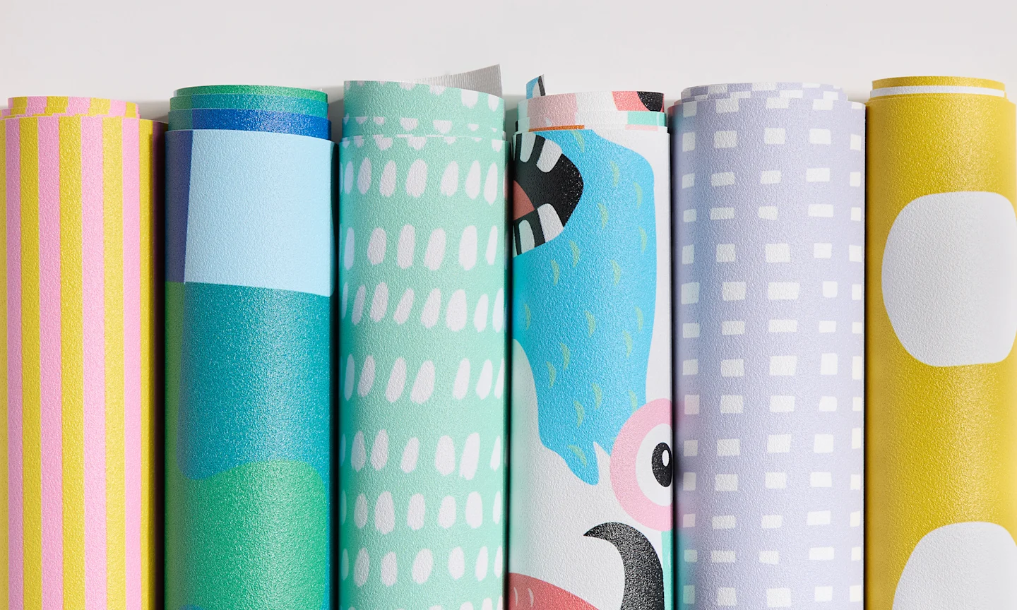Rolls of vinyl wallpaper with kid friendly designs.