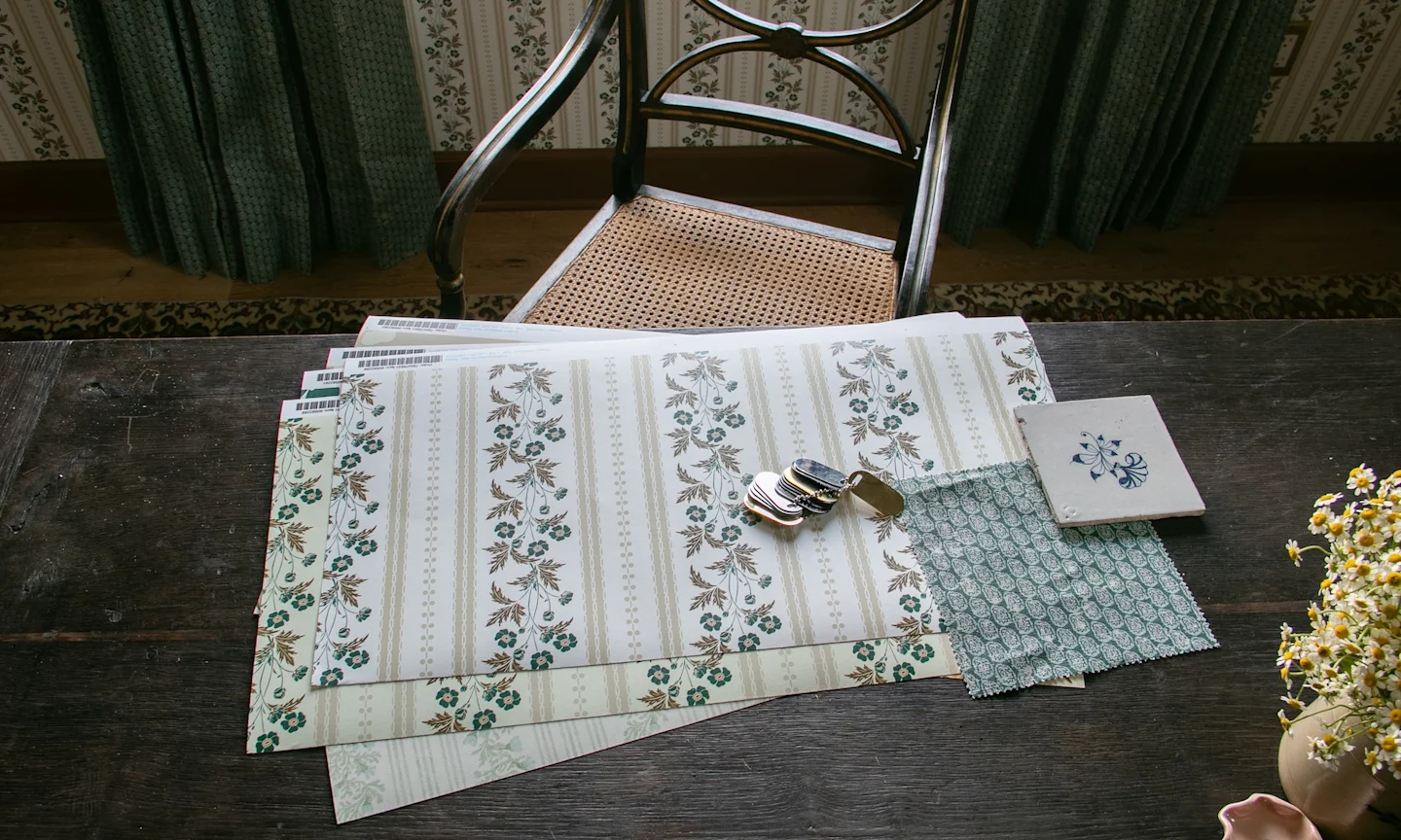 Shot of several wallpaper samples on a wooden desk