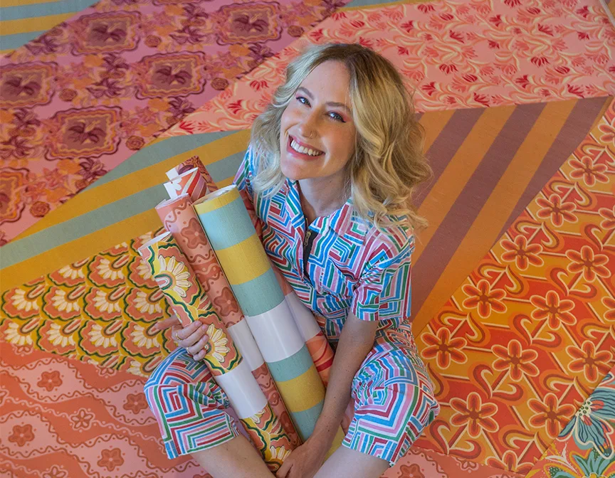 Dani Dazey holding rolls of Spoonflower wallpaper.