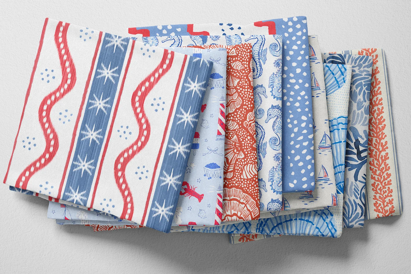 Colorful folded Spoonflower fabric with a coastal Americana theme.