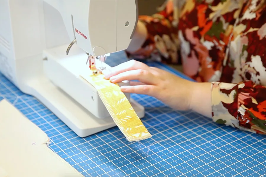 MaryAshlynn stitching the fly shield with her sewing machine